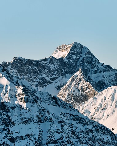 Mountain panorama with snow-covered peaks in Kleinwalsertal, Austria, during winter. | © Kleinwalsertal Tourismus eGen • Photographer: Oliver Farys